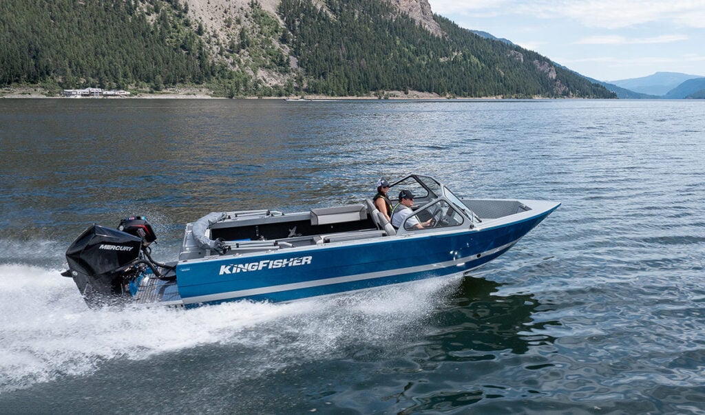 KingFisher 2025 Escape blue hull aluminum fishing boat running on mountain lake