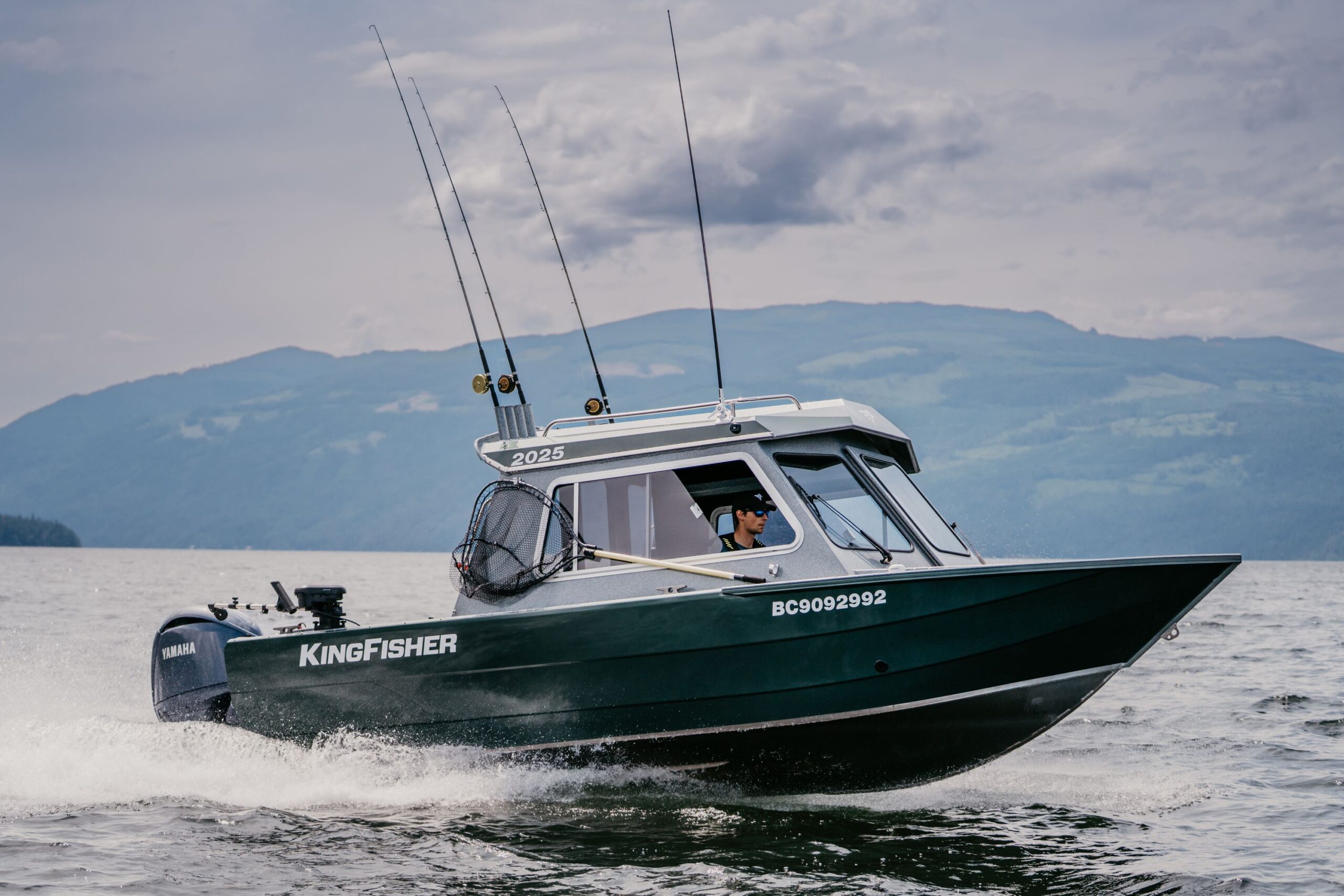 2025 KingFisher Escape HT aluminum fishing boat running at speed on mountain lake